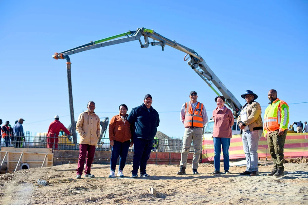 Councillors in front of construction machinery at the building site