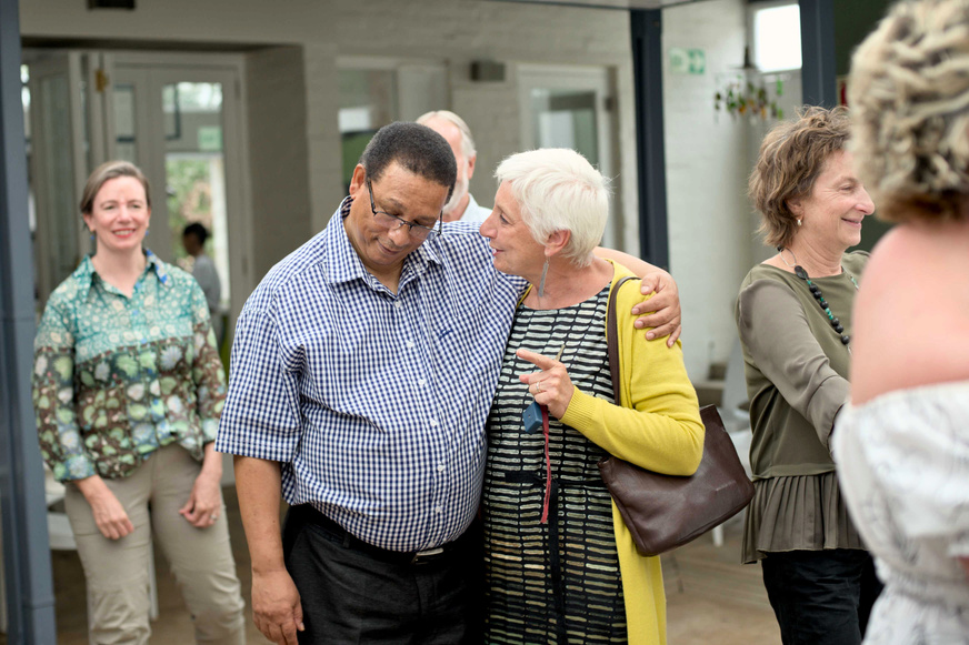 Minister hugging elderly lady