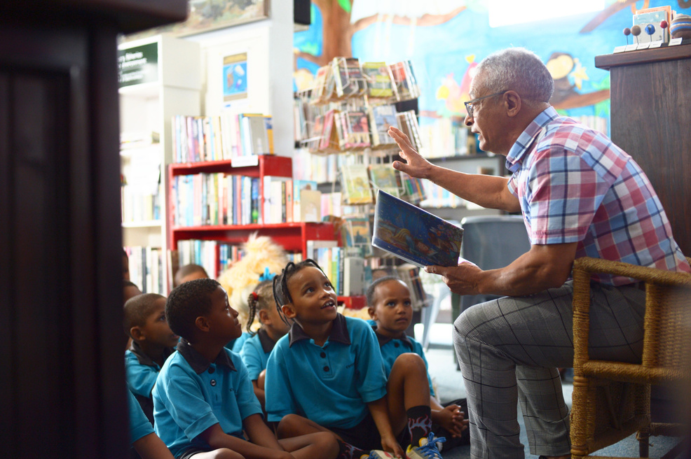 Gentleman reading to kids