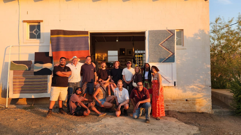 Group photo of the team in front of the factory building