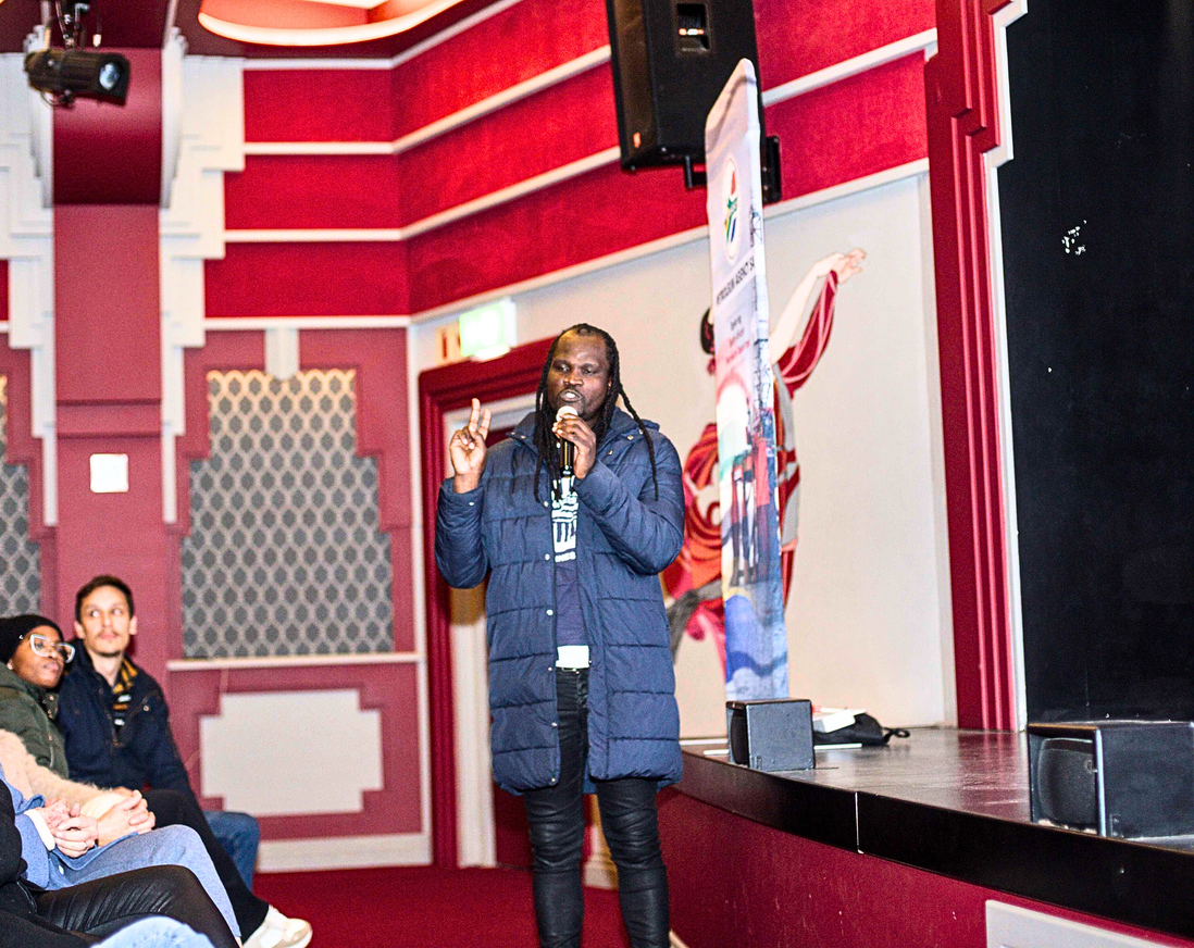 Person with microphone addressing audience